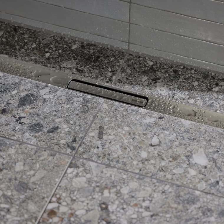 A água escorre através de um elegante perfil em aço inox A água escorre através de um elegante perfil em aço inox